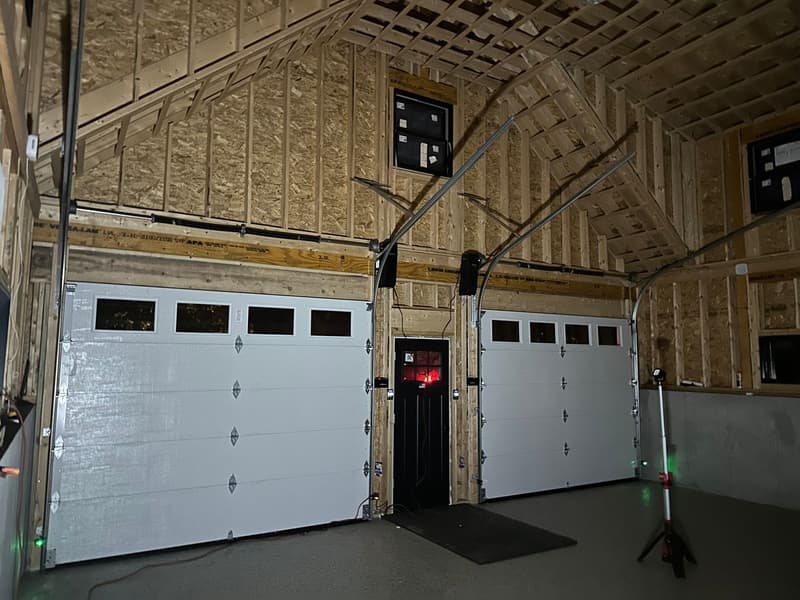 Multi-bay commercial garage doors with work van parked outside